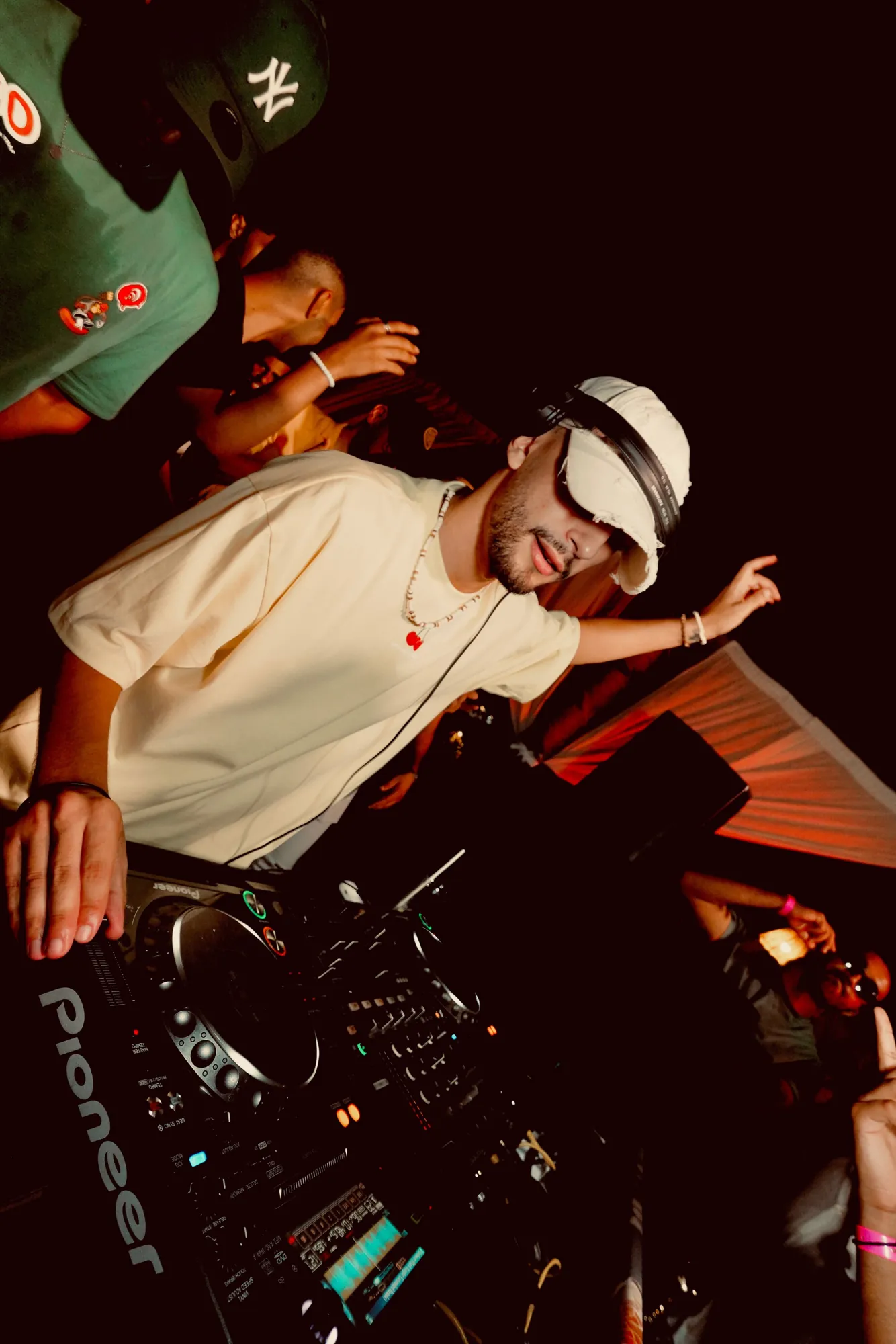 ASHI behind the decks, arms up