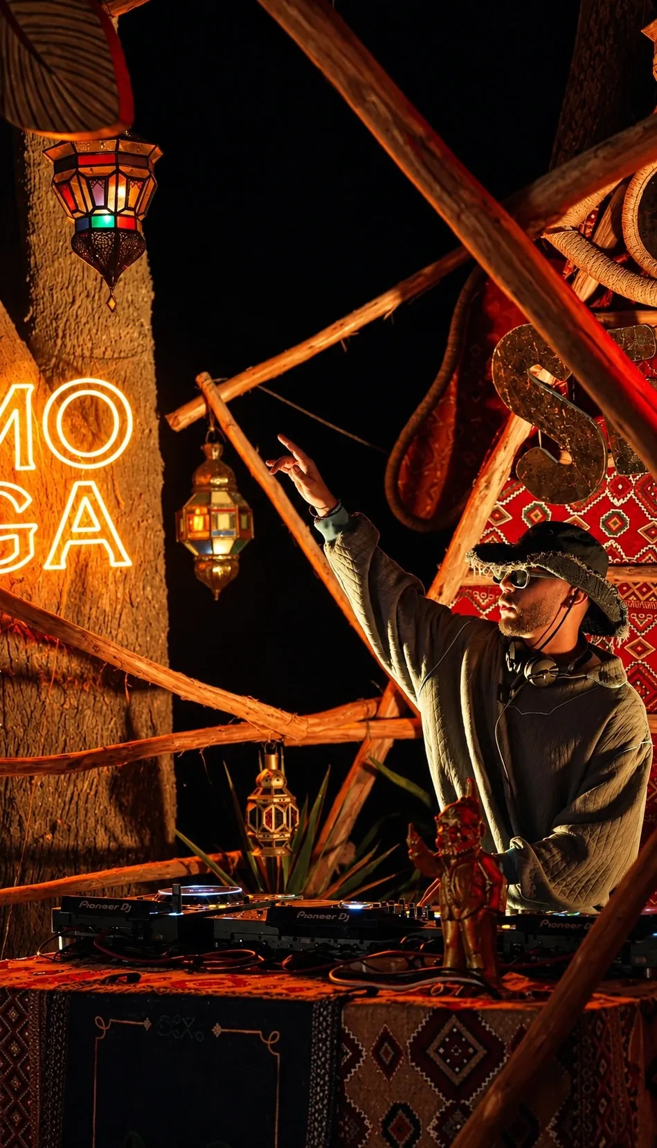 ASHI pointing to the sky beside the MOGA neon, Secte stage at Moga Off