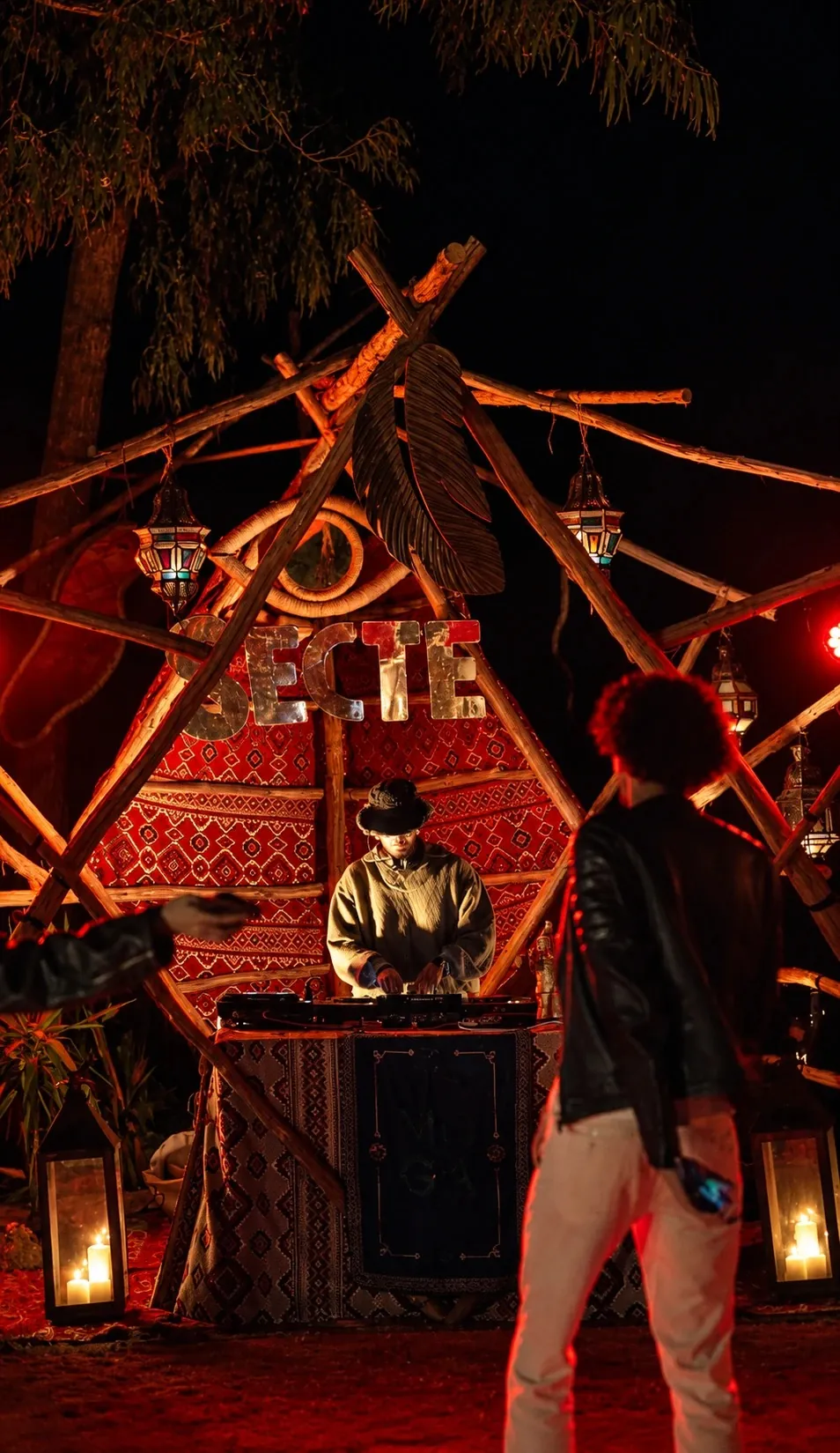 ASHI behind the decks of the candle-lit Secte stage at Moga Off