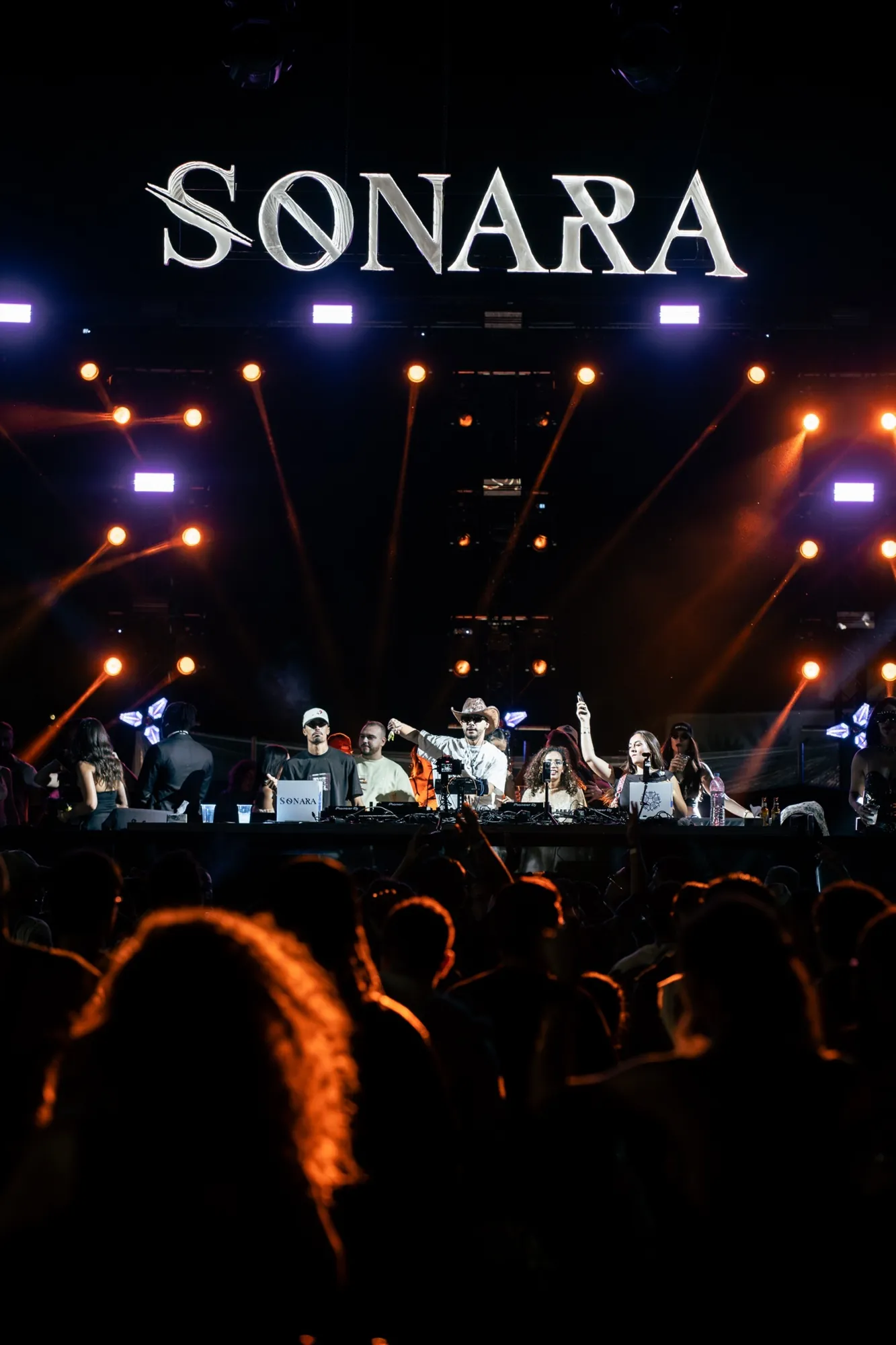 ASHI on the Sonara main stage, the illuminated SONARA sign above the booth